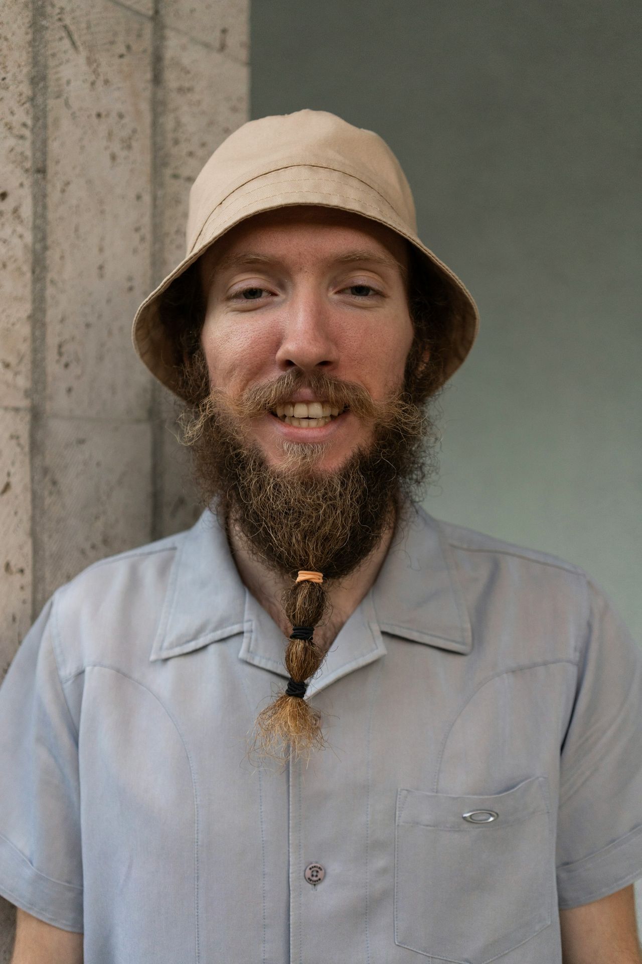 a man with a beard wearing a hat